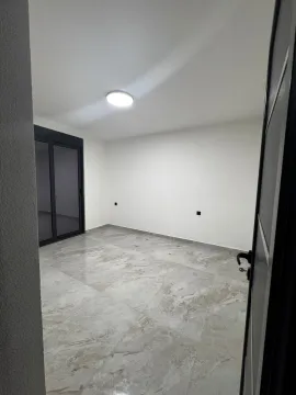 Empty bright room with tiled floor and balcony doors. - image 8