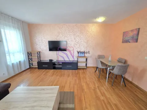 Living room with a dining area, wooden flooring, and a TV console. - image 16