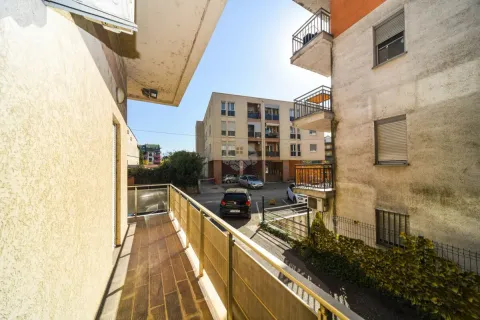View from the balcony overlooking buildings and parking. - image 5