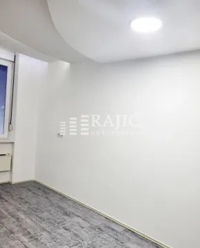 Empty bright room with white walls and gray flooring. - image 5