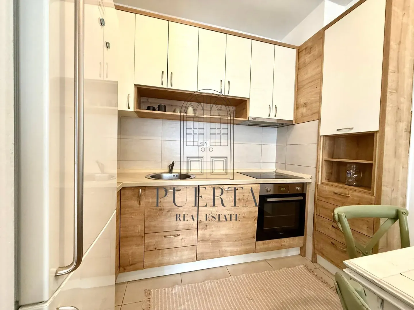 Modern kitchen with wooden elements and built-in appliances.