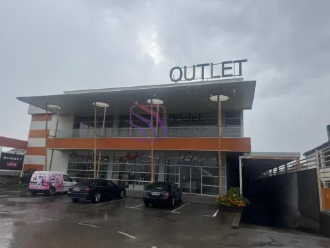 Exterior view of the commercial building with a parking lot in front. - image 2