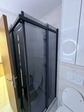 Modernly equipped bathroom with a shower cabin and sanitary ware. - image 11