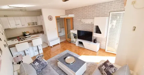 Living room with an open-plan kitchen and dining area. - image 9