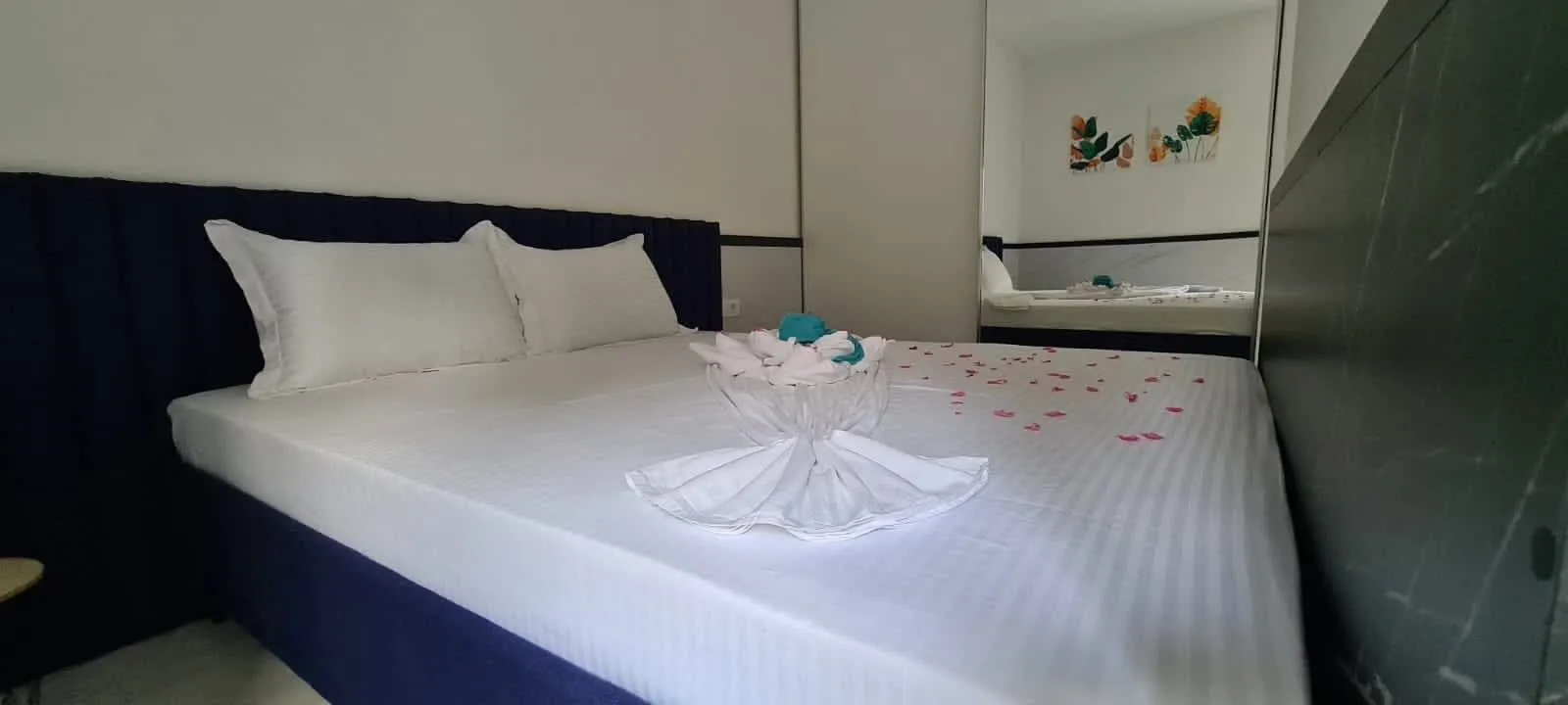 Furnished bedroom with a double bed and wardrobe.