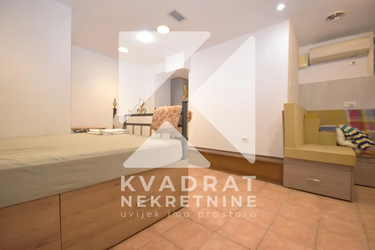 Furnished bedroom with a bed and a built-in bench.