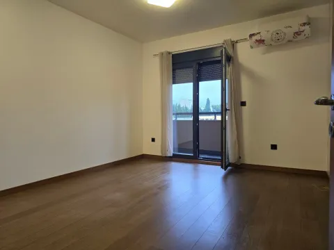 Empty room with wooden flooring and access to a terrace. - image 3