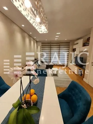 Living room with dining area and modern furniture.