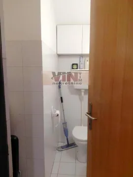 View of a small bathroom with white tiles and sanitary ware. - image 2