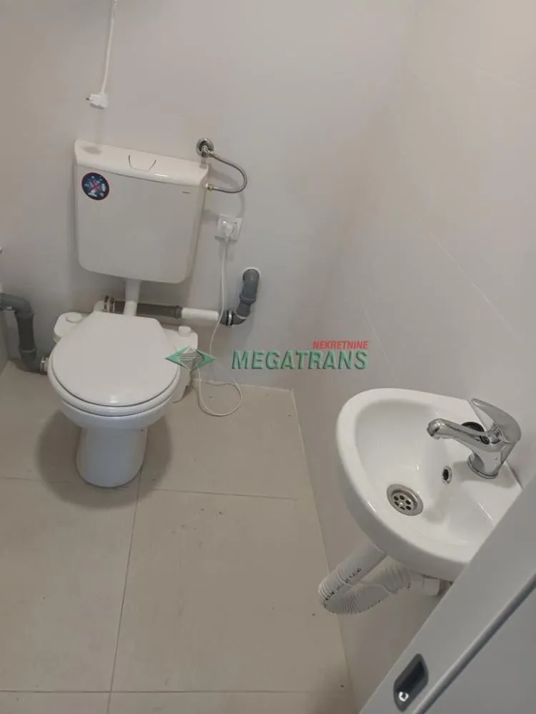 Smaller bathroom with a toilet and a sink.