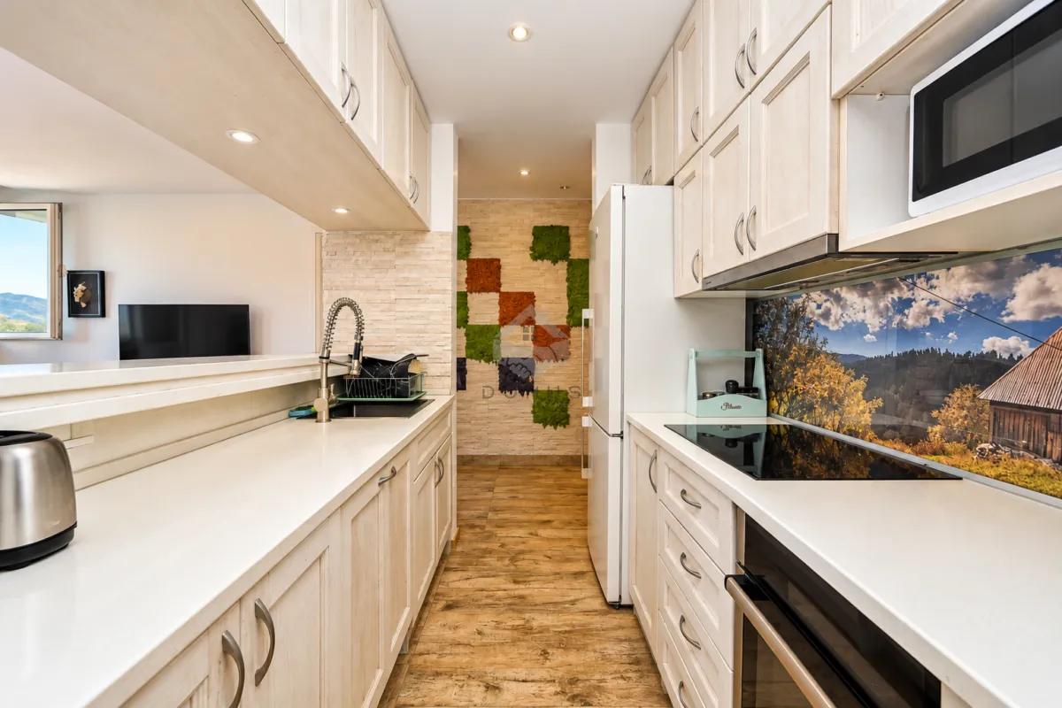 Modern kitchen with wooden cabinetry, white countertops, and built-in appliances.