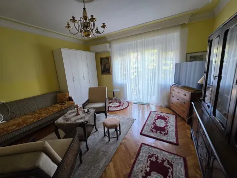 Furnished living room with a sofa set, television, and cabinet. - image 4