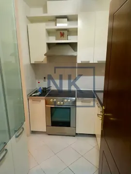 Small kitchen with white cabinets and a stove. - image 2