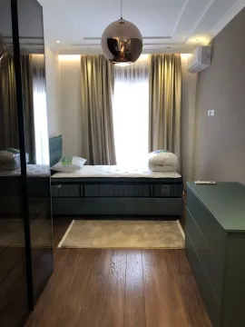 Modern bedroom with a bed, wardrobe, and elegant lighting. - image 12