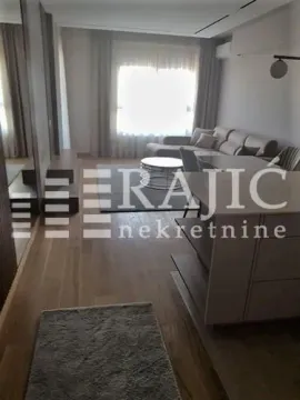 Living room with a sofa and dining table. - image 2
