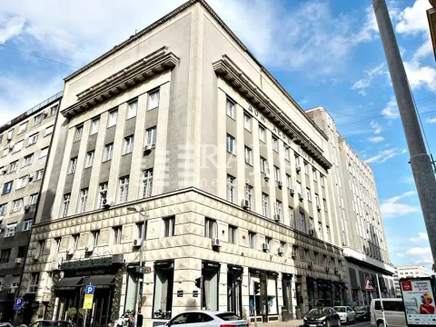 Exterior view of a residential and commercial building with a street in the foreground. - image 9