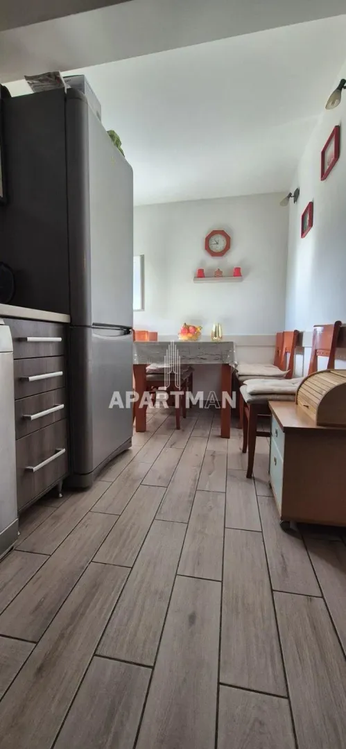 Smaller kitchen with a dining area and a wooden table.