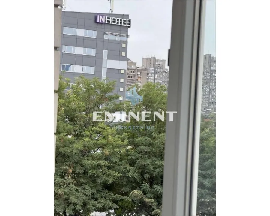 View from the apartment overlooking surrounding buildings and greenery.