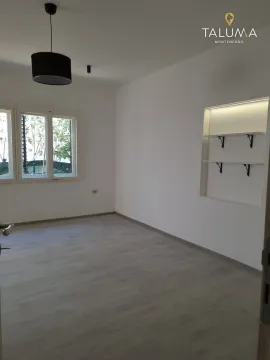 Empty room with light walls, laminate flooring, and built-in shelving. - image 5