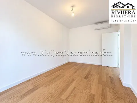 Empty bright room with hardwood flooring and an air conditioning unit. - image 5