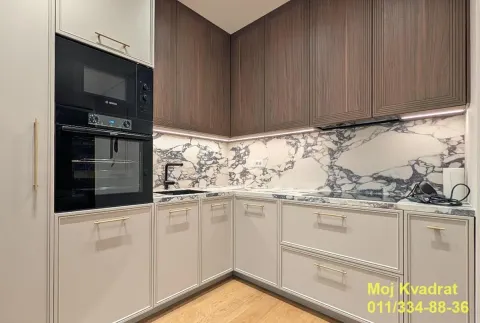 Modern kitchen with built-in appliances and a marble backsplash. - image 4
