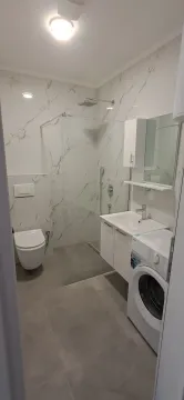 Moderne kupatilo sa tuš kabinom, umivaonikom i veš mašinom. - image 9