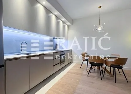 Modern kitchen with a dining area and built-in appliances.