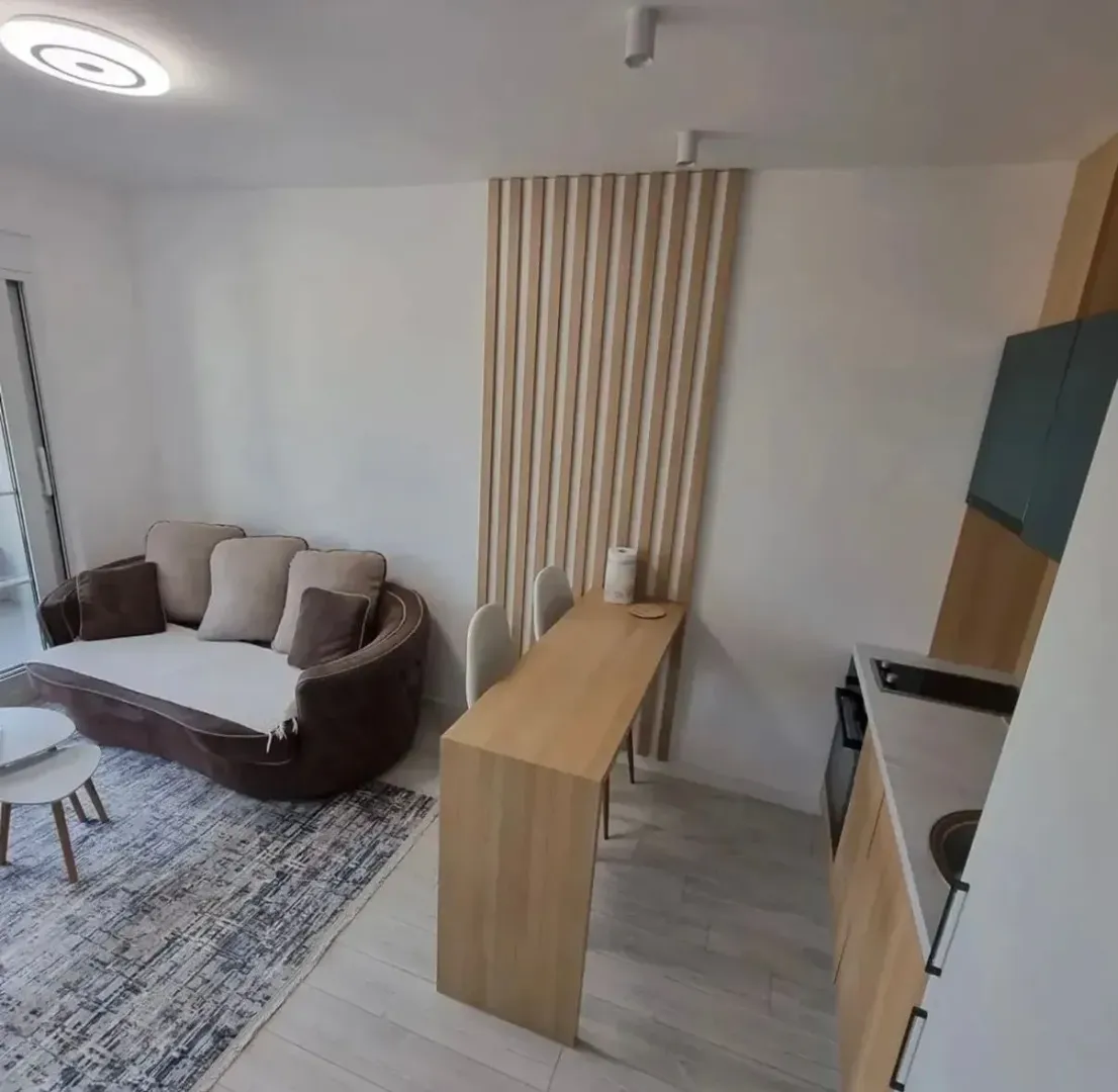 Living room connected to the dining area and kitchen in a modern interior.
