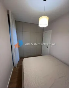 Bedroom with a double bed, built-in wardrobe, and a window with curtains. - image 8