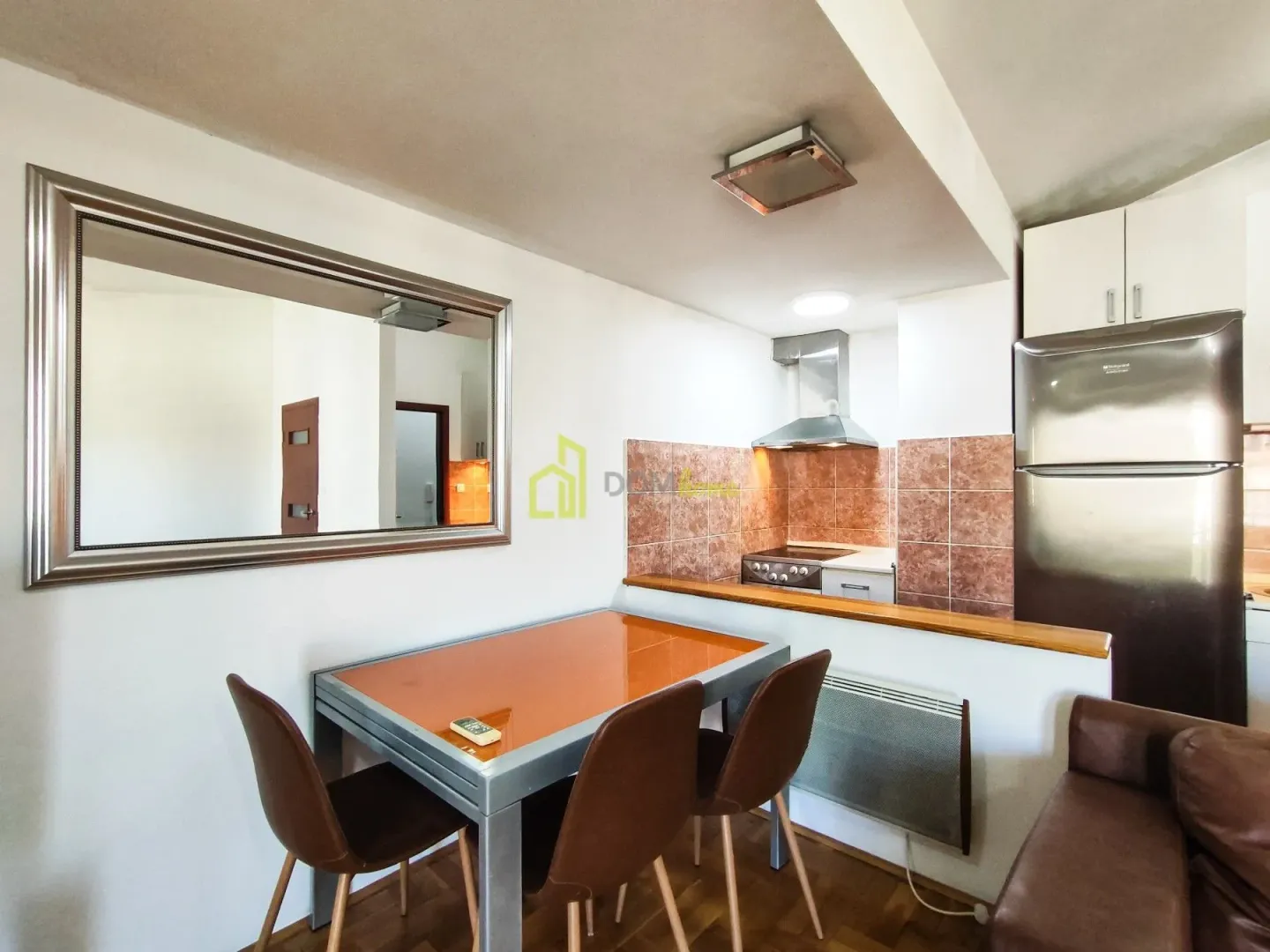 Smaller kitchen connected with the dining and living area.