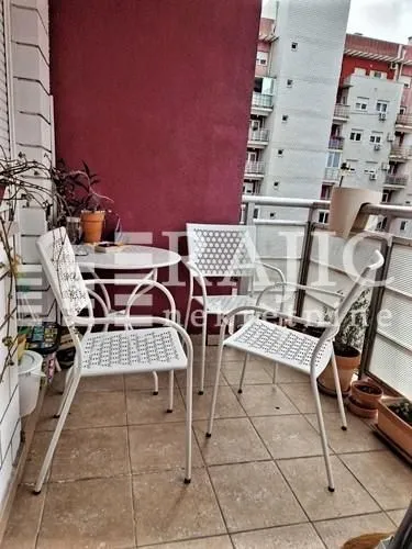 Furnished terrace with seating set and view of surrounding buildings.