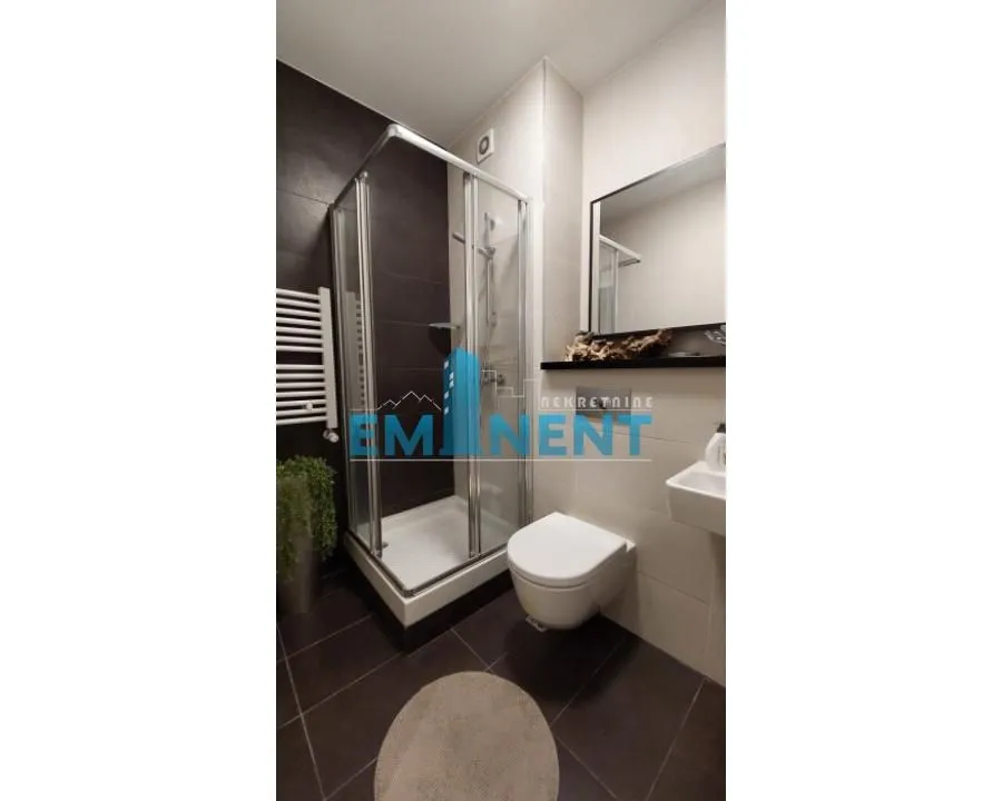 Modern bathroom equipped with a shower cabin and sanitary ware.