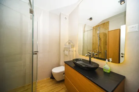 Modern bathroom with a shower cabin, washbasin, and mirror. - image 11