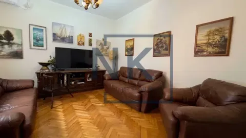 Living room with leather furniture sets, parquet flooring and a TV. - image 11