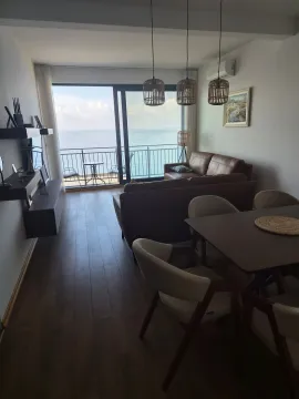 Spacious living room with a dining area and a sea view. - image 16