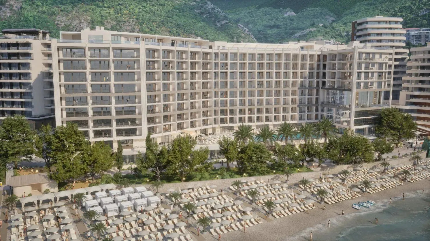 Pogled na spoljašnjost modernog hotela sa plažom i ležaljkama.