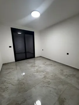 Empty bright room with ceramic tiles and balcony doors. - image 6