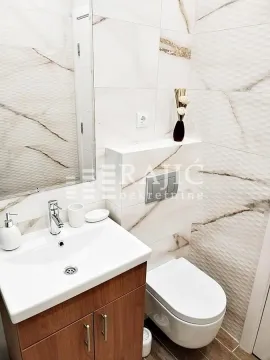 Modern bathroom equipped with a sink and toilet. - image 8