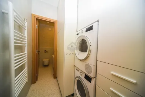 Bathroom with built-in washing and drying machine and a towel radiator. - image 25