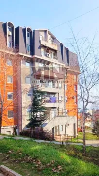 Pogled na spoljašnjost stambene zgrade sa balkonom i okruženjem. - image 6