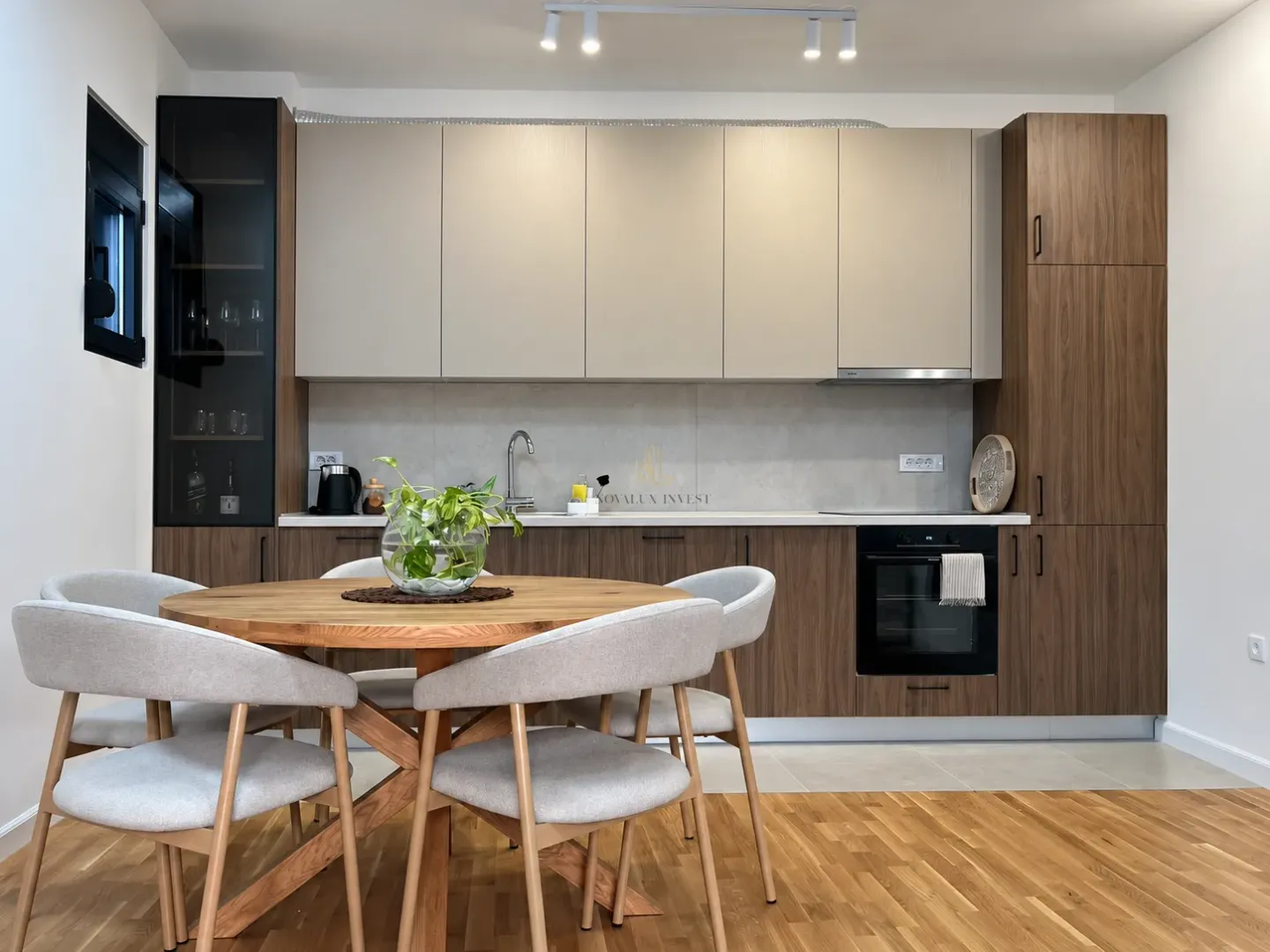 Modern kitchen with wooden cabinetry and a dining table with chairs.