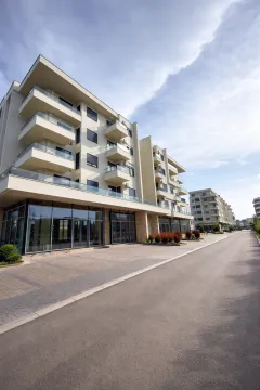 Modern residential building with balconies and a paved driveway. - image 2