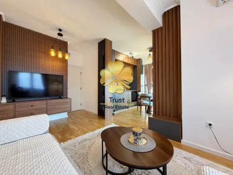 Modern living room with wooden wall paneling and a view of the dining area. - image 4