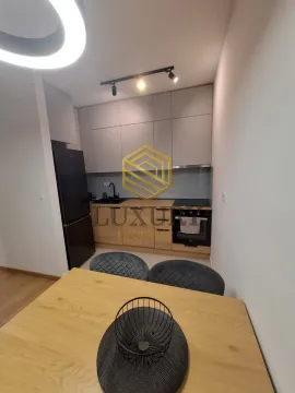 Modern kitchen with a dining table. - image 7