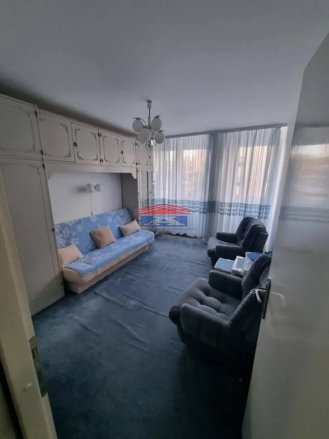 Living room with sofa, armchairs and closets.