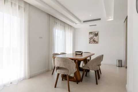 Dining area with a wooden table and upholstered chairs in a bright interior. - image 21