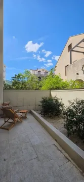 Tiled courtyard with sun loungers and decorative plants. - image 5