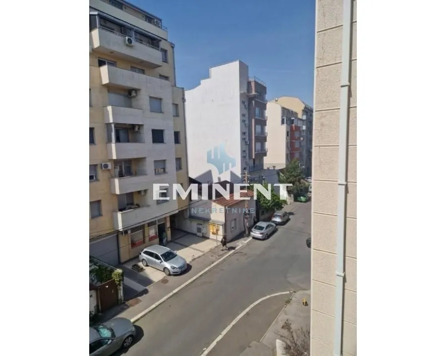 View from the window of surrounding buildings and the street.