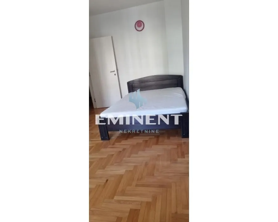 Bedroom with a double bed and parquet flooring.