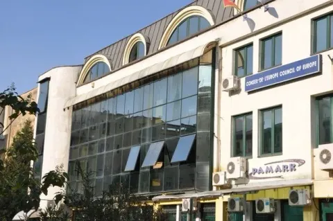Facade of a modern office building with glass panels. - image 2